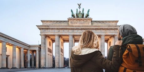 Young couple sightseeing at Brandenburg Gate in winter 