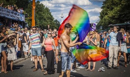 People with rainbow flags at the Pride Parade in Berlin